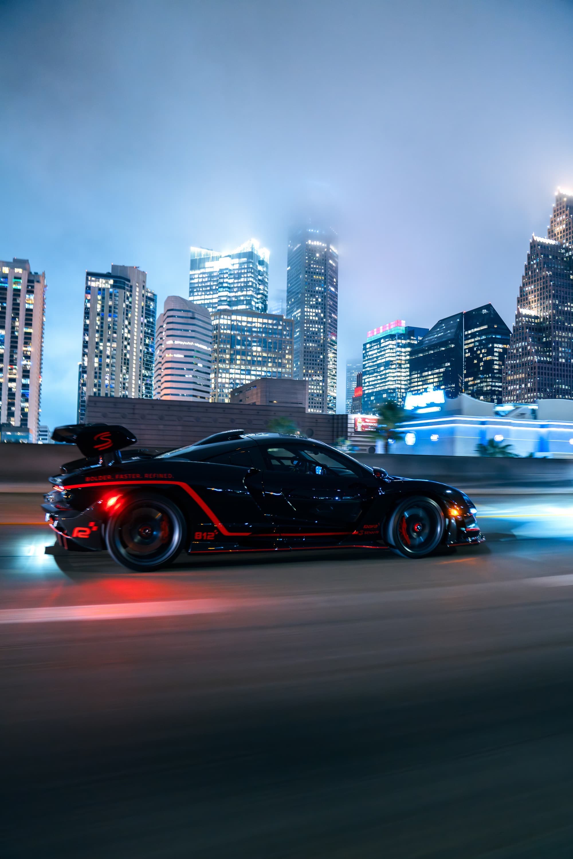 McLaren Senna at speed against the Houston skyline at dusk